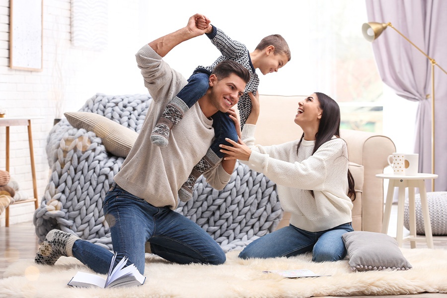 Blog - Happy Family with Small Son Having Fun and Playing on the Floor at Home